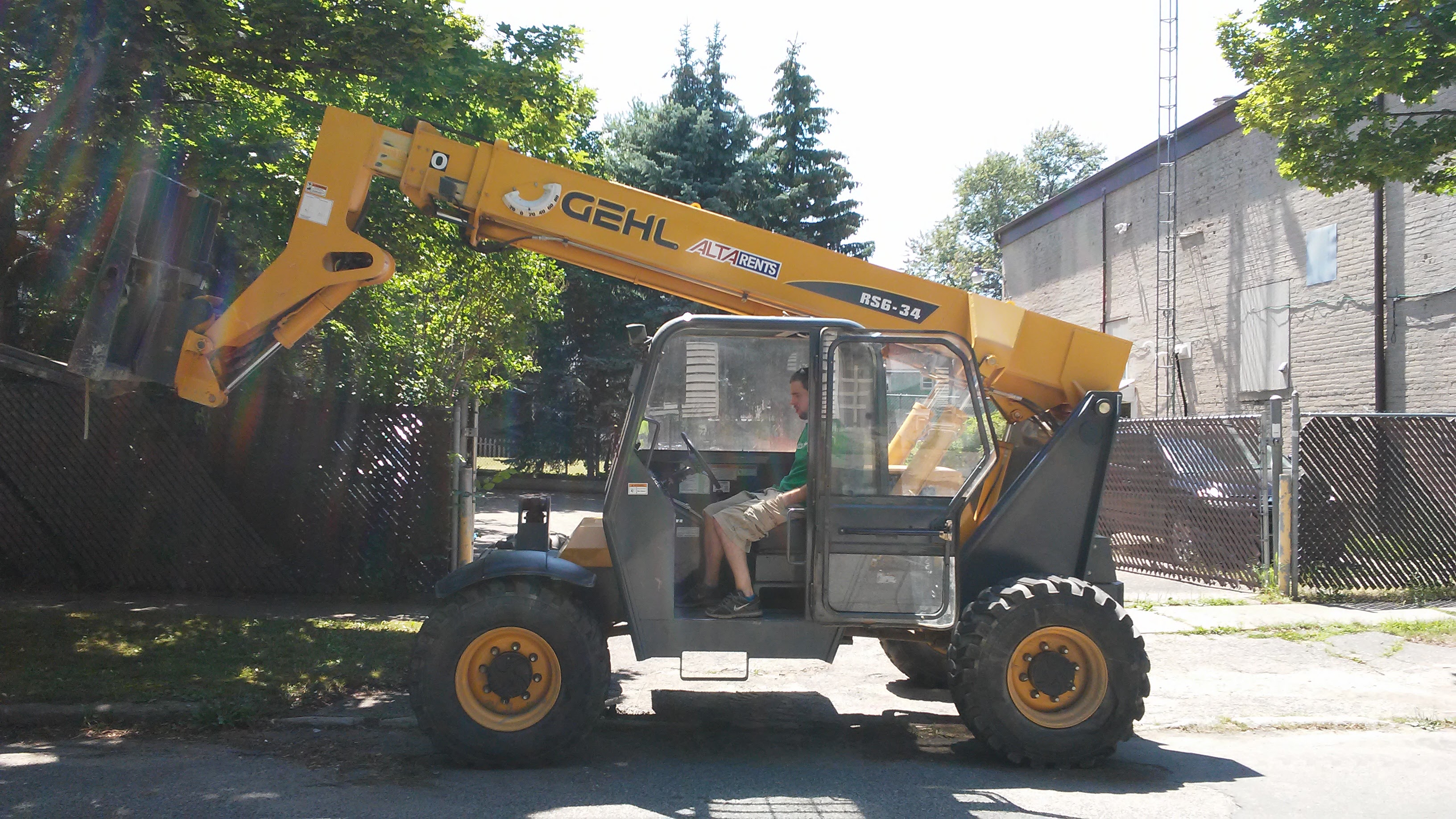 Yellow Gehl lift vehicle being operated during fiber infrastructure installation.