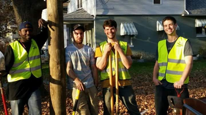 Spark Fiber crew posing together beside a newly installed telephone pole in the neighborhood.